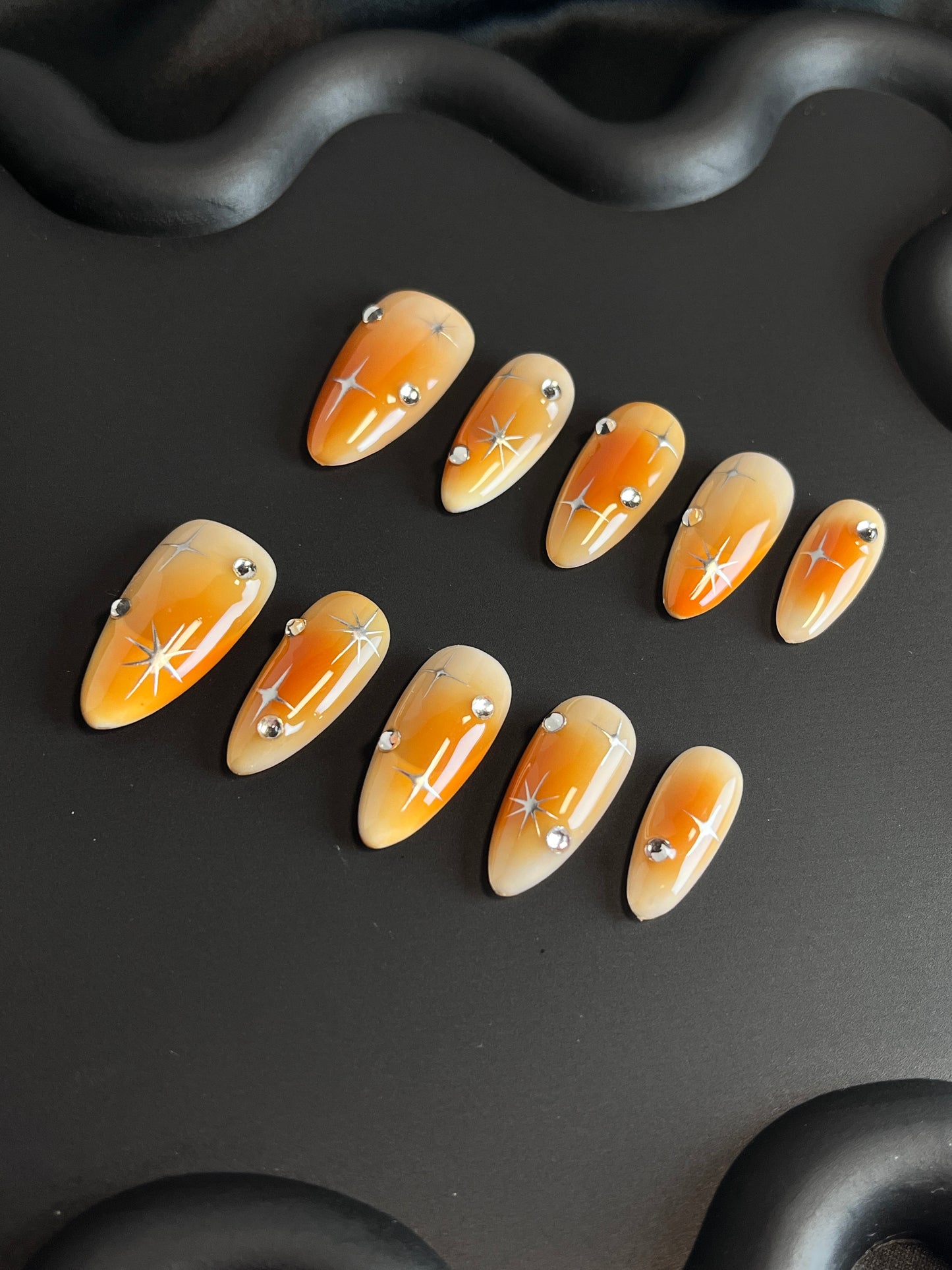 Orange Aura Star Almond Ombre Nails