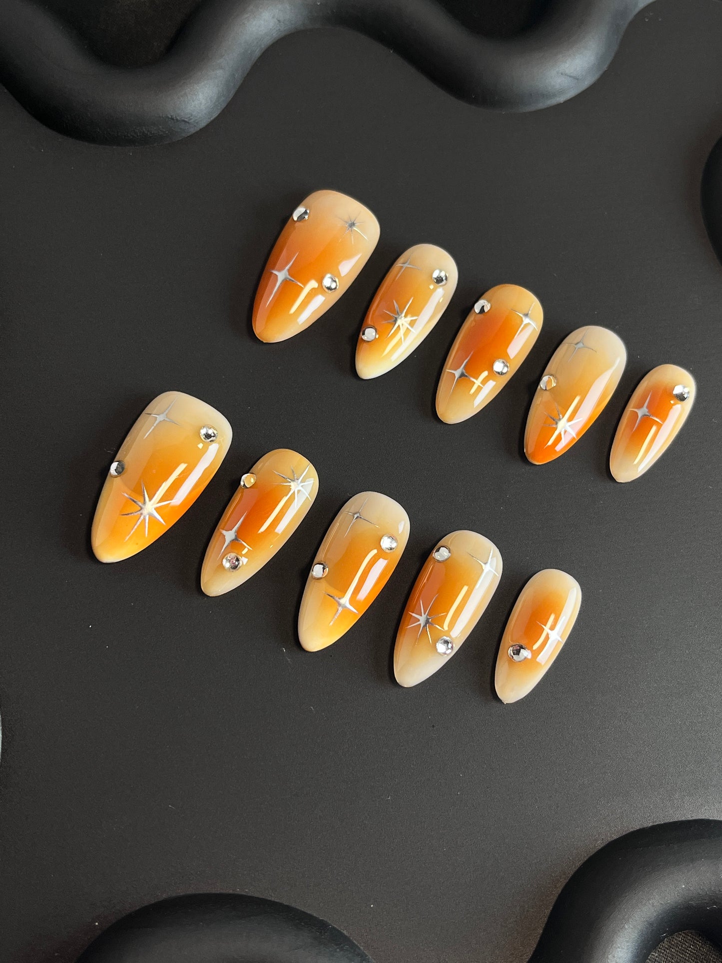 Orange Aura Star Almond Ombre Nails