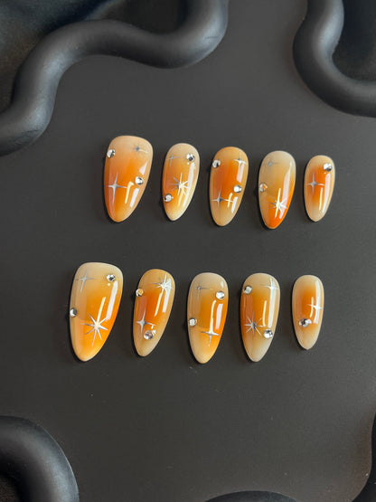 Orange Aura Star Almond Ombre Nails