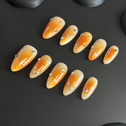 Orange Aura Star Almond Ombre Nails