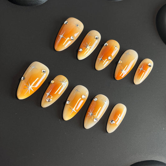 Orange Aura Star Almond Ombre Nails