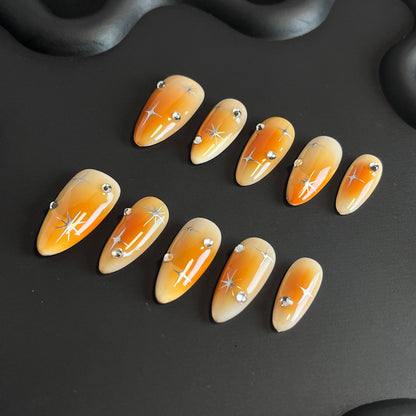 Orange Aura Star Almond Ombre Nails