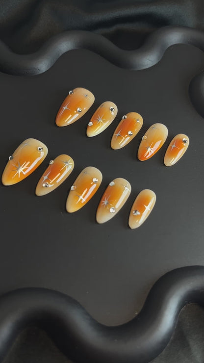 Orange Aura Star Almond Ombre Nails